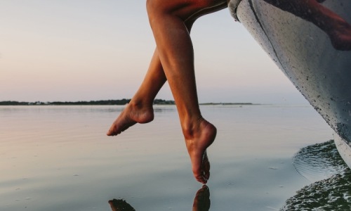 a person's legs hanging out of a boat